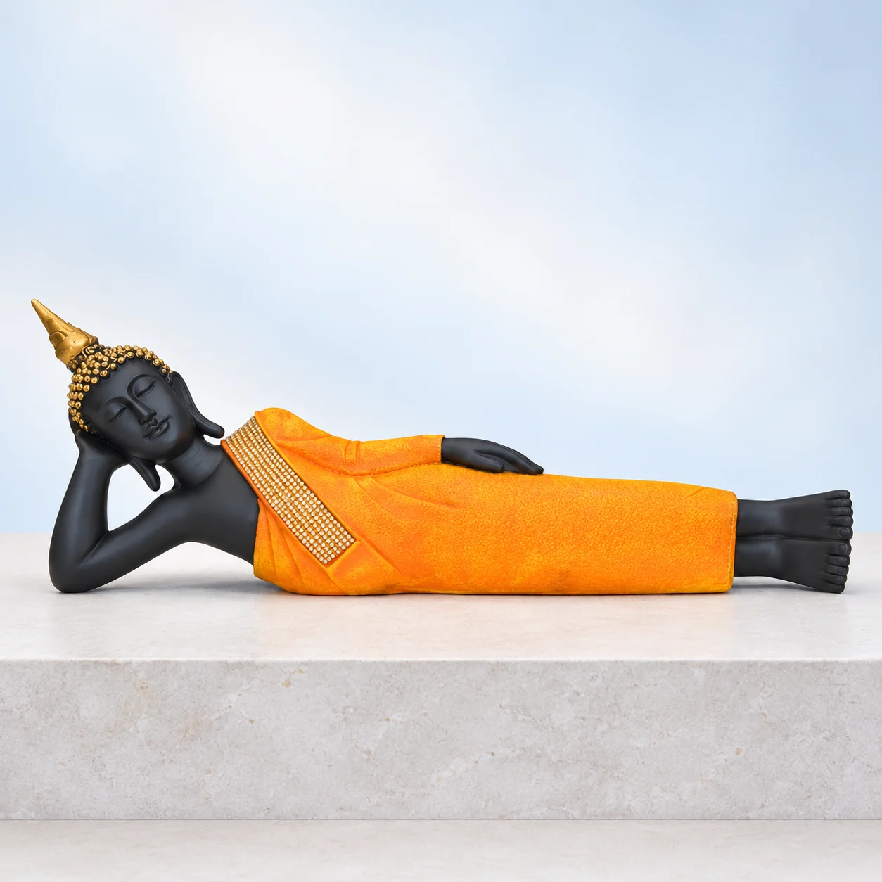 Reclining Buddha in Orange Robe — styled image Styled product image of Reclining Buddha in Orange Robe