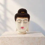Styled product image of White Buddha Face with Brown Hair